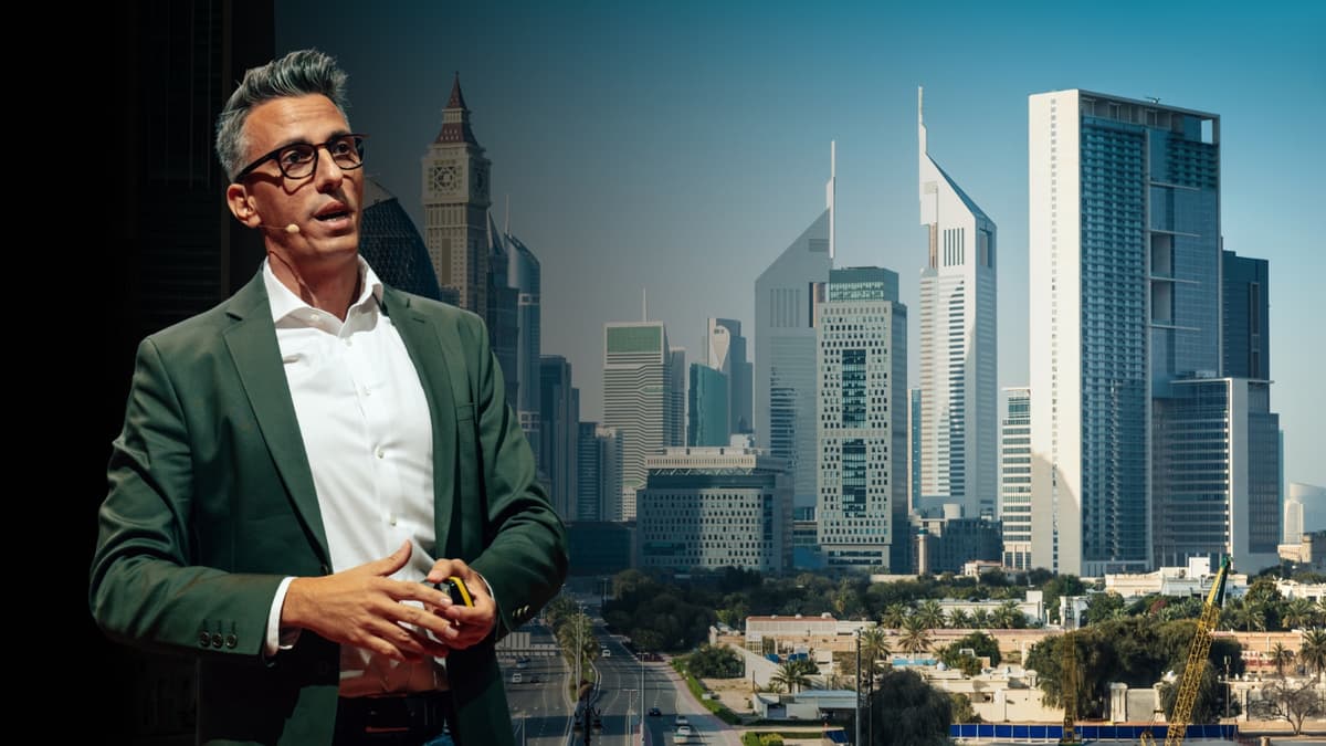 Daniel Garofoli speaking in front of the Dubai skyline